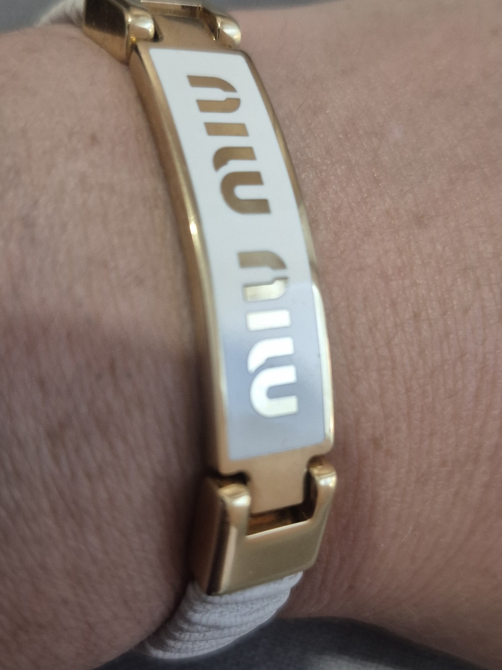 Miu Miu Gold Tone Bracelet with White Logo Plaque